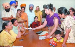 Punjab State Women Commission Chairperson Gurdev Kaur Sangha listens to the grievances of NRI women in Jalandhar on Tuesday. 