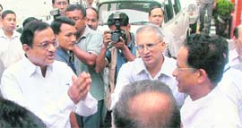 Home Minister P Chidambaram greets Assam CM Tarun Gogoi as Home Secretary GK Pillai looks on before leaving Guwahati on Tuesday.