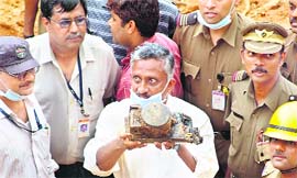An official holds a black box recorder recovered from the wreckage of a crashed Air India plane in Mangalore on Tuesday.