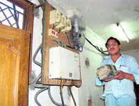 A Power Corporation employee with a faulty meter removed from a hotel during a drive in Haridwar on Wednesday