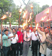 Railways employees protest in support of their demands in Dehradun on Wednesday. 