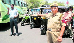 A traffic policewoman on duty on a busy road in Jammu