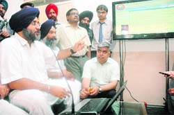 Deputy Chief Minister Sukhbir Singh Badal inaugurates an online National Permit scheme for truck operators in Patiala on Wednesday.