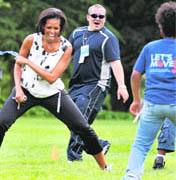 US First lady Michelle Obama plays with kids at an event on the South Lawn of the White House in Washington on Tuesday to kick-off the South Lawn Series.  AP/PTI