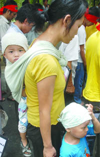 A Myanmar resident participates in a protest along with her children against the country's military elections at Jantar Mantar in New Delhi on Thursday.