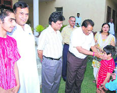 District and Sessions Judge Shiva Sharma meets a differently abled child at Disha in Sirsa on Thursday.