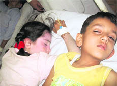 Two of the victims of adulterated ice-candies under treatment at the district hospital, Reasi.