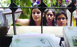 Students collect admission forms at Kirori Mal College in North Campus on Friday.