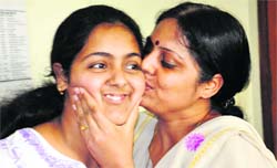 The mother of Latika Arora, a topper, kisses her on a school campus in Haridwar on Friday.