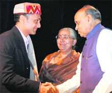 Actor Rahul Bose shakes hands with Chief Minister Prem Kumar Dhumal at the inauguration of the Indian Panorama Film Festival at the Gaiety Theatre in Shimla on Friday