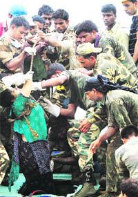 Cobra Force jawans pull out the body of a passenger from a coach of the Gyaneswari Express after it derailed and collided with an incoming train following an explosion on the track at Saridha in West Midnapore district of West Bengal on Friday.