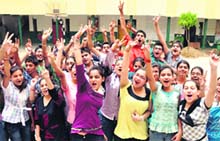 Students of DAV Public School, BRS Nagar, jump with joy after achieving a CGPA between 9 and 10, in Ludhiana on Friday. 