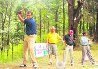 A player gets ready to hit a shot at the Governors Golf Cup Tournament at the Raj Bhawan in Nainital on Saturday. 