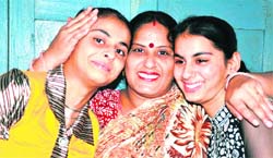 Nupur Sharma (in yellow top), with her mother and sister, rejoices after topping in her school.
