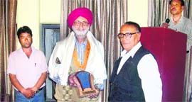 Harbhachan Singh being felicitated on the occasion of Hindi Patrakarita Diwas in Mussoorie on Saturday.