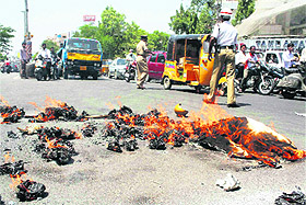 Traffic police diverts vehicles from the part of road where pro-Telangana activists started a fire in Secunderabad on Saturday.