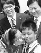 President Pratibha Patil kisses a child on her arrival at White Horse Temple in China on Saturday.