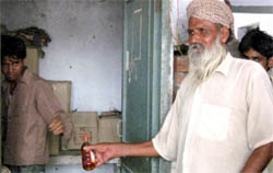 A Bacchus lover purchasing liquor from the vend running in the premises of the SHC of village Rana, of Ferozepur.
