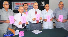 Members of the Dehradun Ex-servicemen Organisation release their annual report in Dehradun on Sunday.