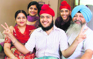 City topper Sukaran Singh with his family in Ludhiana on Sunday.