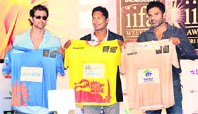 Hrithik Roshan, Sunil Shetty and Sri Lankan cricketer Kumar Sangakkara hold cricket jerseys during IIFA news conference in Mumbai.