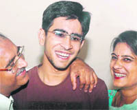 Tarun Mangla with his parents in Bathinda on Sunday.
