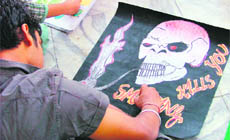 A student participates in a poster-making contest at Green Land Senior Secondary School in Ludhiana.