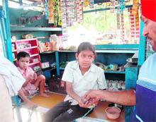 A girl sells tobacco at a shop in Patiala on Monday. 