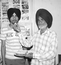 Dharminder Singh, who topped Mohali district in class XII, along with his father in Mohali.