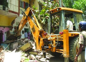 An MCD bulldozer demolishing an unauthorised construction at Tank Road, Karol Bagh in New Delhi on Monday.