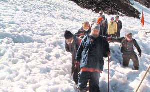 Pilgrims negotiate a snow-bound area in Pitthoragarh district.