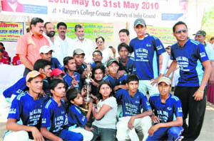 The Brave Cricket Club, Delhi, receive the trophy after winning the All-India DSL Aloe Vera Trophy in Dehradun on Monday.
