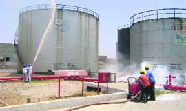 Firemen battle a fire during a mock drill conducted at the oil depot in Hisar on Monday.