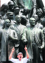 A demonstrator shouts anti-Israel slogans from the Ataturk memorial at Taksim square in Istanbul on Monday. 