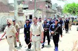 Police team and commandos of the operations cell of the Chandigarh police carry out a flag march in Mauli Jagran on Tuesday