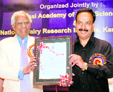 Dr RB Singh (left) awards certificate of National Academy of Dairy Sciences to Dr AK Srivastava