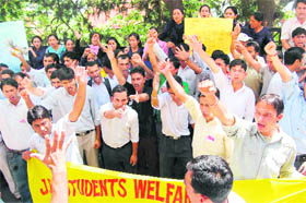 Activists of the JBT Students Welfare Association shout slogans for the acceptance of their demands at the DC office in Shimla on Tuesday. 