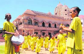 Inmates of Srila Prabhupada International Gurukul perform religious rites attired in saintly dresses
