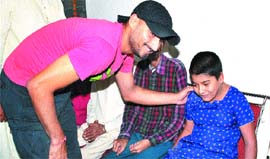 Cricketer Harbhajan Singh interacts with a girl at Apahaj Ashram in Jalandhar.
