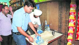 Health officials collect samples of mineral water from a vend in Ludhiana on Tuesday.