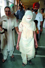 Manjit Kaur, the murder accused, being taken into police custody in Bathinda on Wednesday