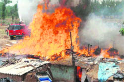 A fire rages as officials struggle to control it at Adarsh Colony, Sector 54, Chandigarh, on Wednesday