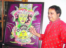Aloke Tirtha Bhowmick describes his painting to media persons in Mussoorie on Wednesday.  