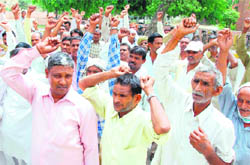 PWD workers hold a protest against the non-payment of their salaries on time in Karnal on Wednesday.