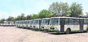 A fleet of air-conditioned SRTC buses await roll out at the Narwal truck yard in Jammu on Thursday.