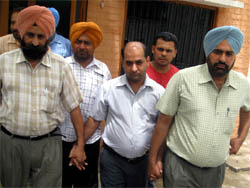 The Vigilance Bureau officials taking the drug inspector Balram Luthra into custody on graft charges in Moga