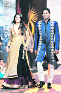 Sri Lankan-born Bollywood actress Jacqueline Fernandez (L) and Sri Lanka cricket team captain Kumar Sangakkara displays designs at a fashion show in Colombo on Thursday. 