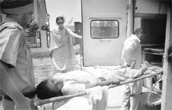 Karamjit Kaur, a member of the Paramedical Karamchari Union, being evacuated from the office of the director, rural development and panchayats, in Mohali on Friday.