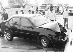 A car, which hit a railing on the Ghaggar bridge, disrupting traffic on the Chandigarh-Ambala highway, at Bhankarpur village in Dera Bassi on Friday.