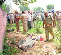 Police personnel inspect the site where a body was found at Phase I, Industrial Area, Chandigarh, on Friday. 
